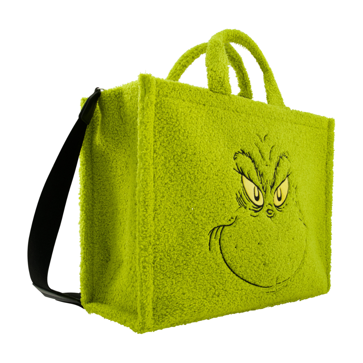 Left angle of Dr. Seuss green Grinch big face sherpa travel tote with trolly band and adjustable removable shoulder strap.